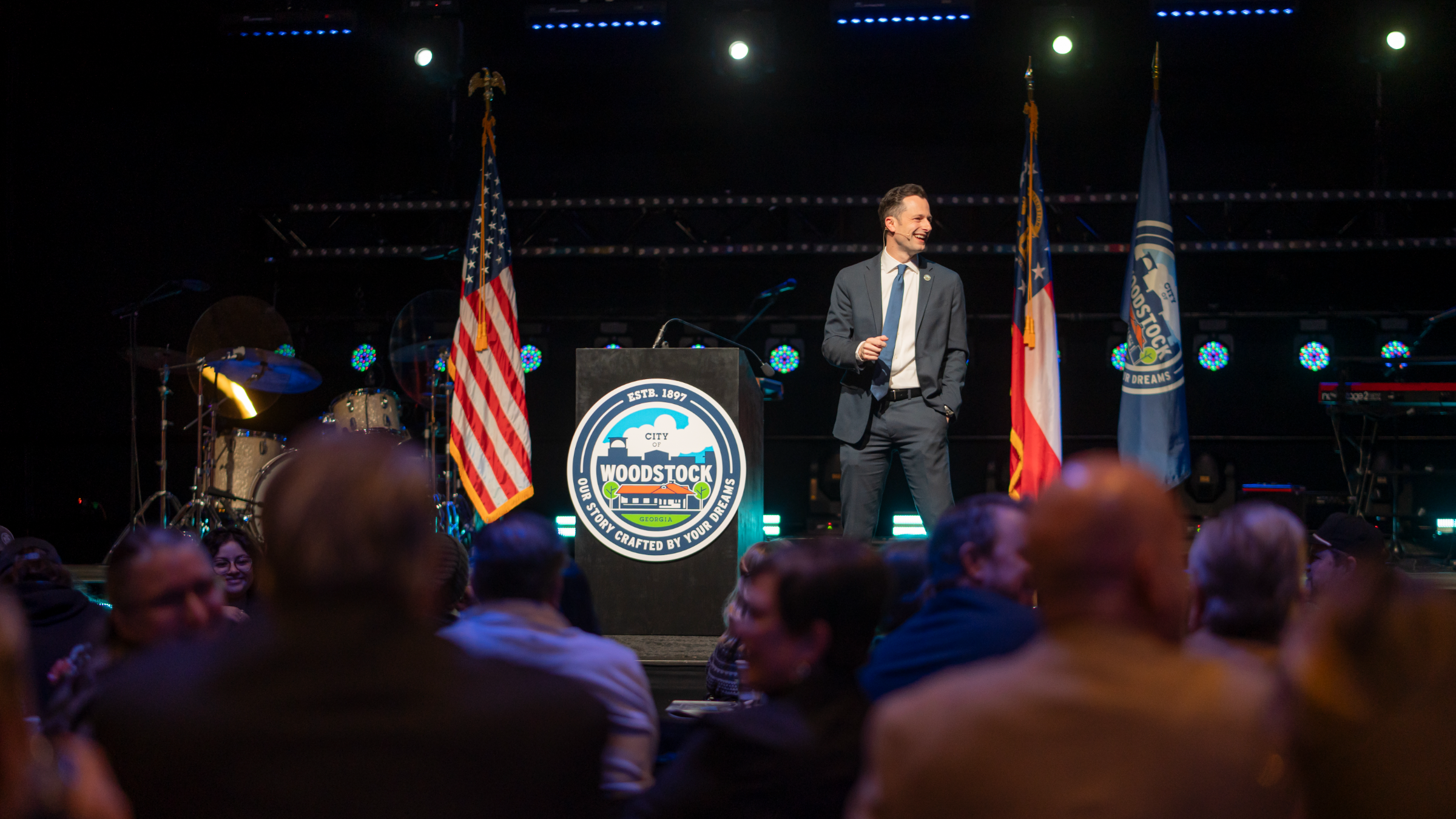 Mayor Caldwell addressing Woodstock residents from the stage at a community event
