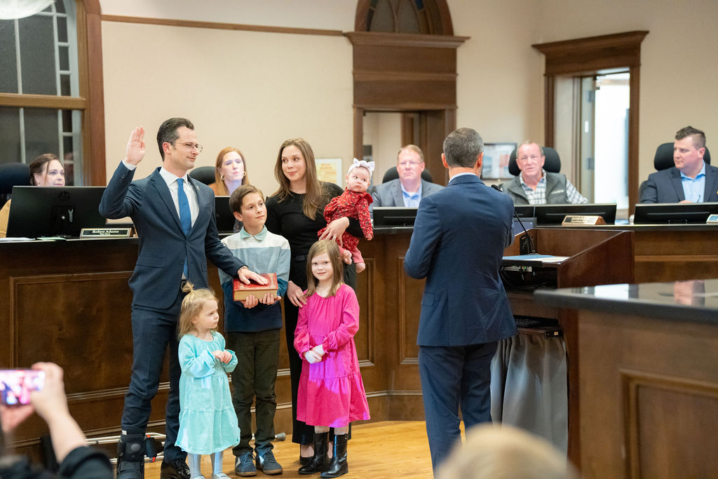 Michael Caldwell takes the oath of office with his family beside him